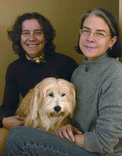 Homeowners Cathy Grier (left), a singer/songwriter, and Michele Steckler, a Broadway producer, relax with their griffon, Marguerite.